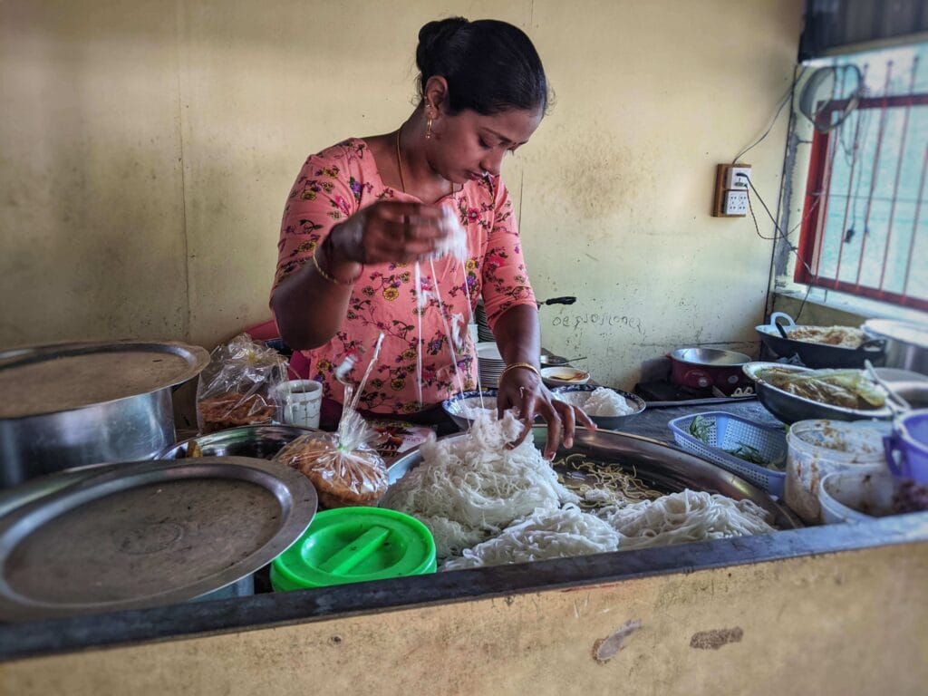 woman making mohinga in dala local market scaled 1