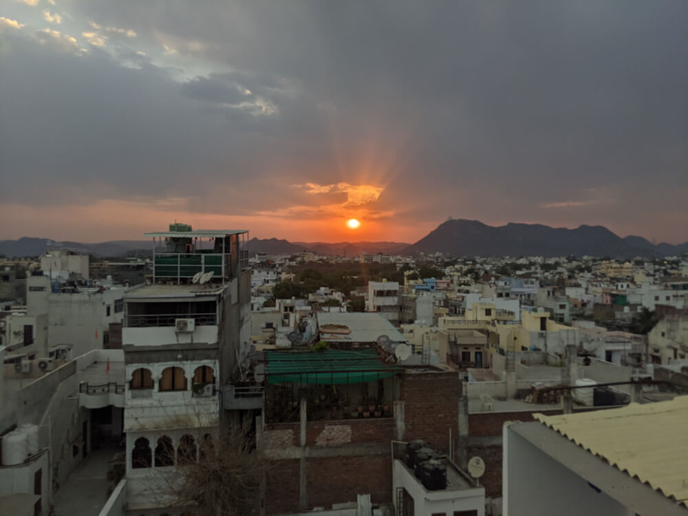 The Pandemic, Start of Our Indefinite Nomadic Journey, Crossing Barricaded Indian State Borders, Collective Helplessness, and Fundraiser Campaigns 16 sunset over udaipur