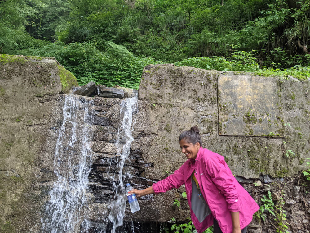 filling water from one chashma natural water source in himachal