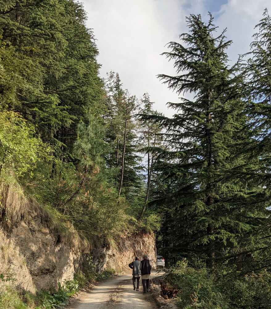 two old man walking together near kanag devi temple