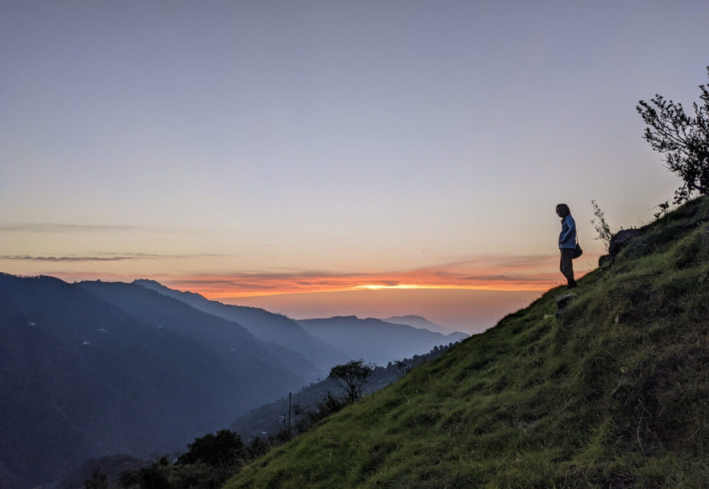 a man standing on a mountain a scene in hard himalayan village life in india to show resilience