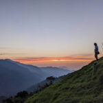 a man standing on a mountain a scene in hard himalayan village life in india to show resilience