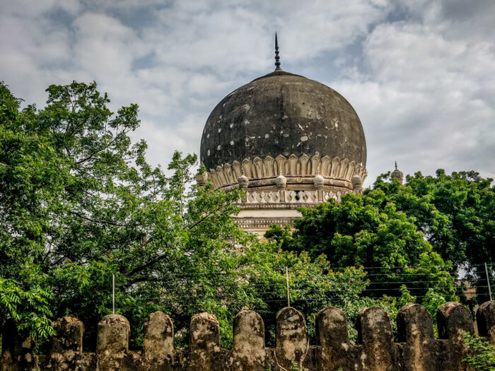 some more tombs peaking from behind bushy trees