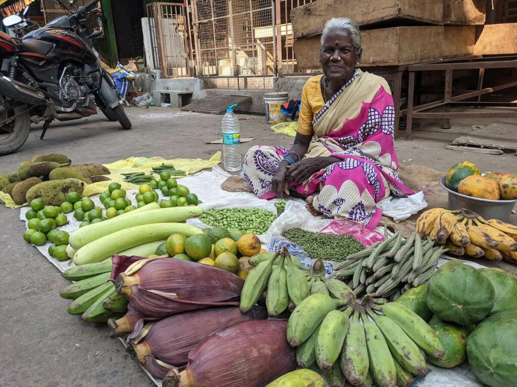 a pondicherry woman selling fruits and vegetables on the street
