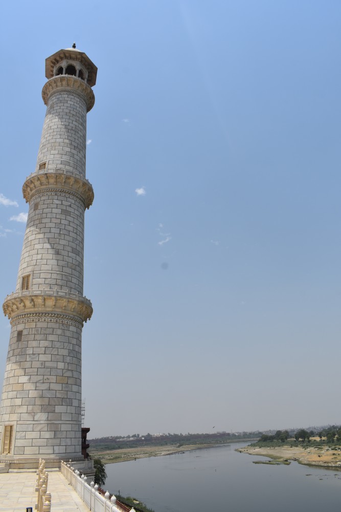 the taj minaret against the yamuna river agra uttar pradesh