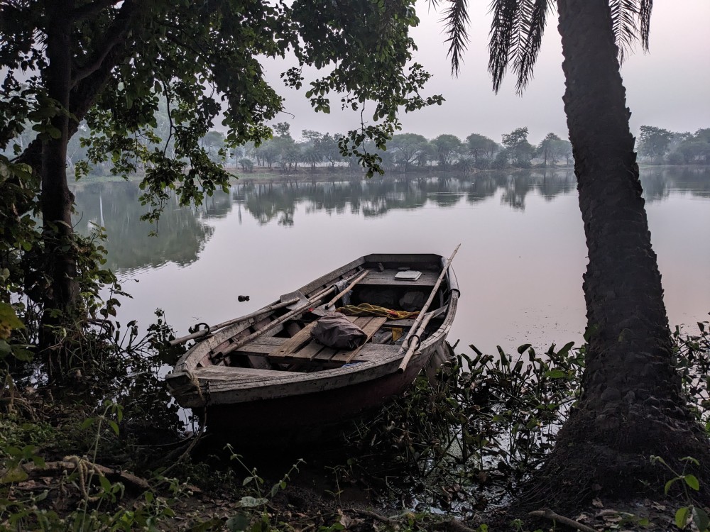 a boat parked at the edge of water used as a feature image for six years of my personal growth and travel blog on my canvas