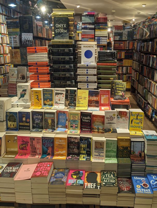 My Best Travel Books of All Time 7 a book stack probably in a book store showing fiction nonfiction history travelogue books book about travelling