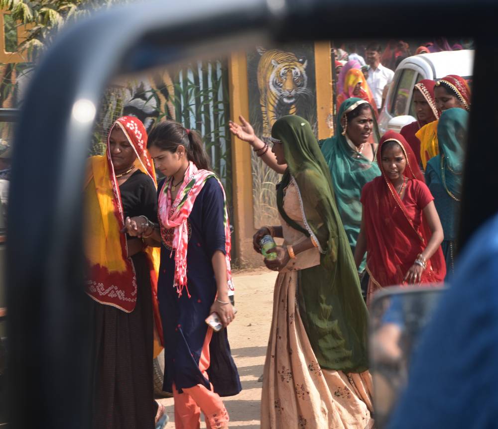 rajasthani women carrying babies wearing colourful clothes in india near ranthambore national park