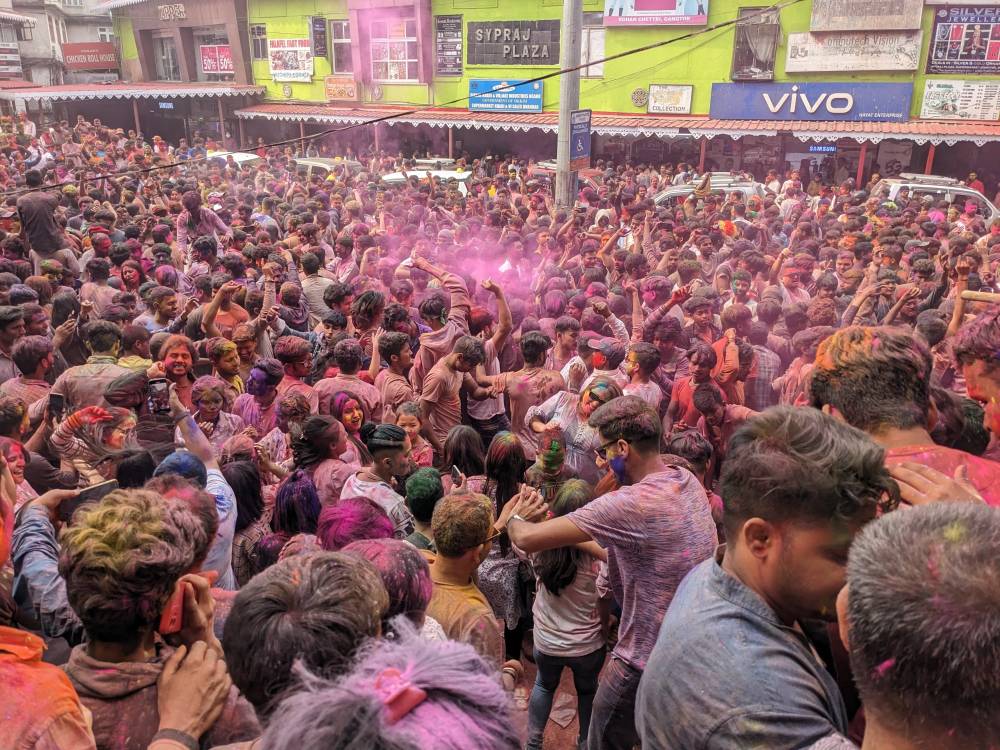 seeing holi celebration in Gangtok sikkim main square hundreds of people in different colours colored by powder
