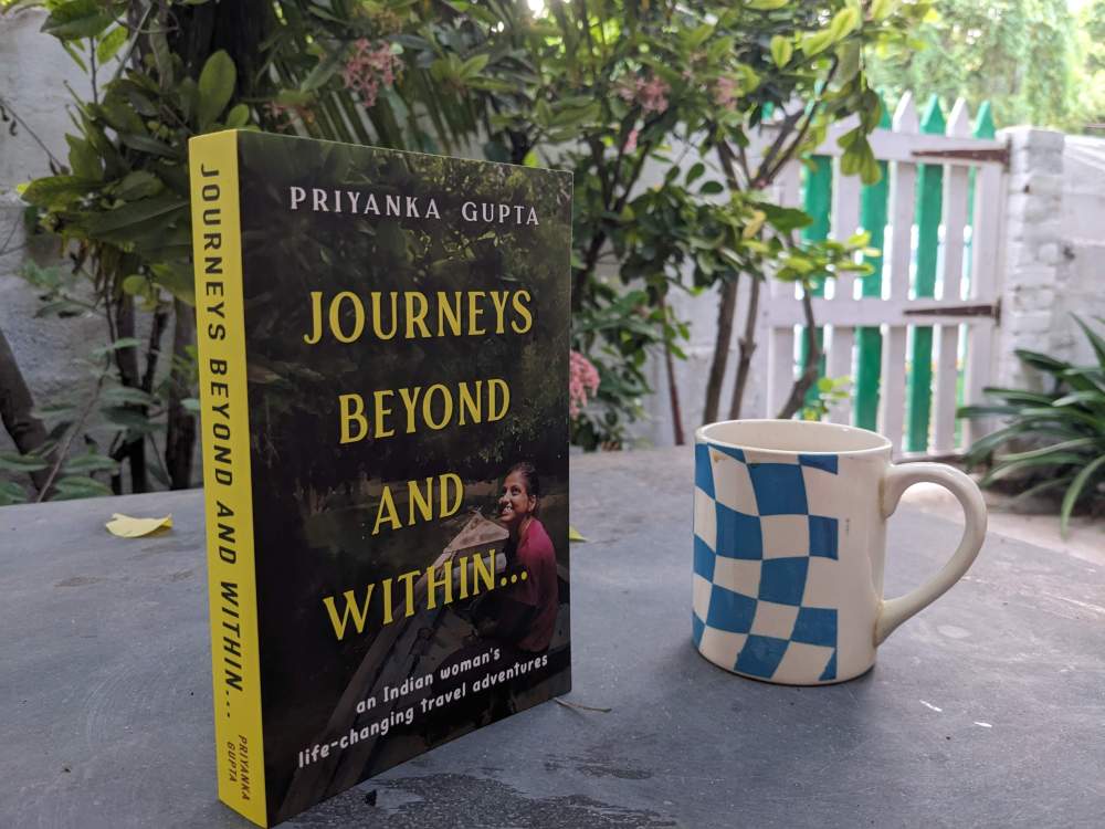 the travel book journeys beyond and within kept on a table standing upright in a garden