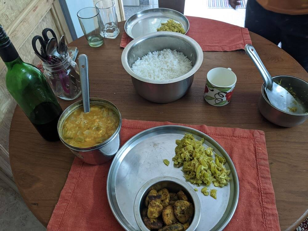 a-homemadel-in-a-tamil-home-in-pondicherry sambhar, rice, banana fry on table