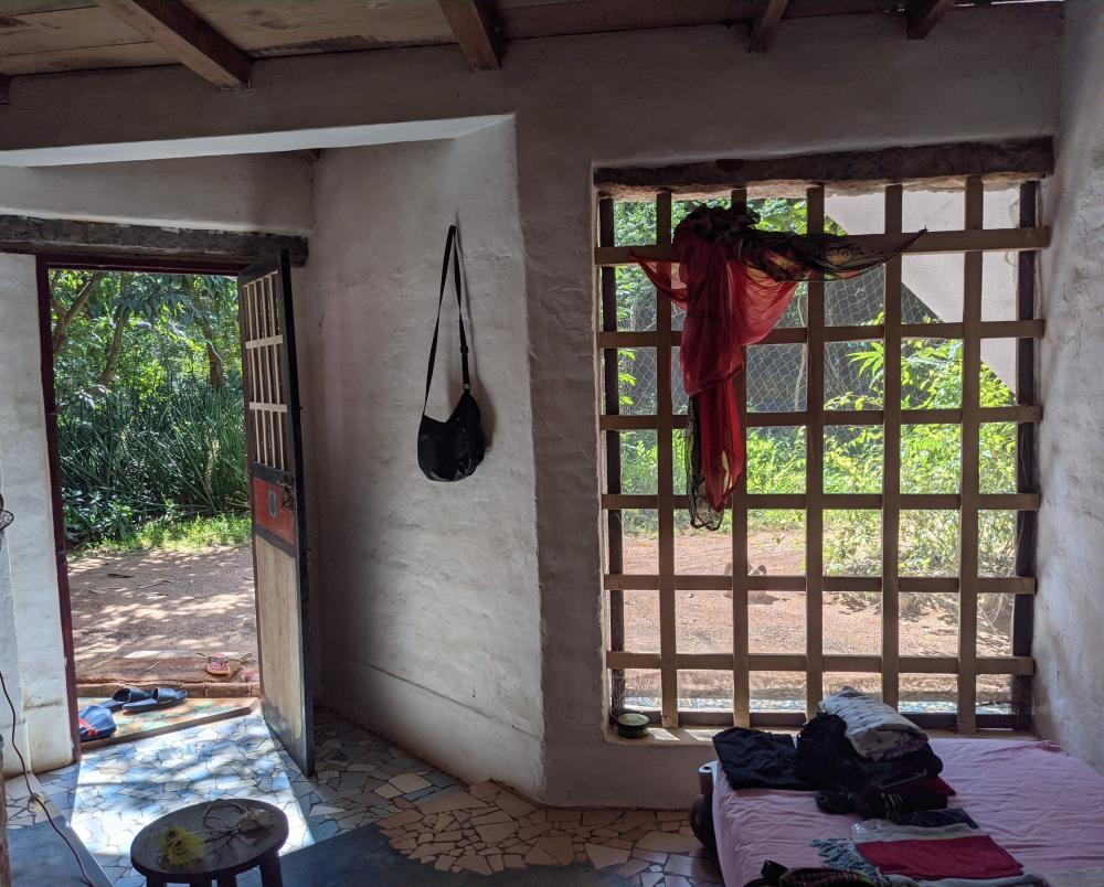 a hut in the middle of a forest stone floor meshed walls (1)