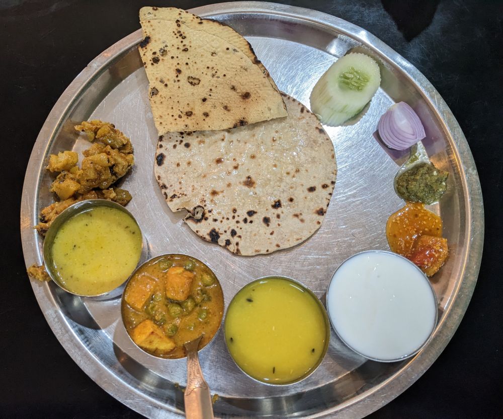 a thali vegetarian in india with dal, vegetables, roti, papadum, curd, pickle (1)