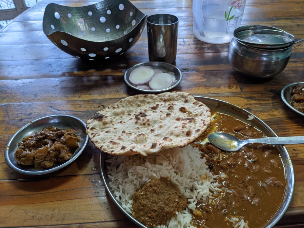 a plate of tandoori roti, kidney beans, onion, vegetable