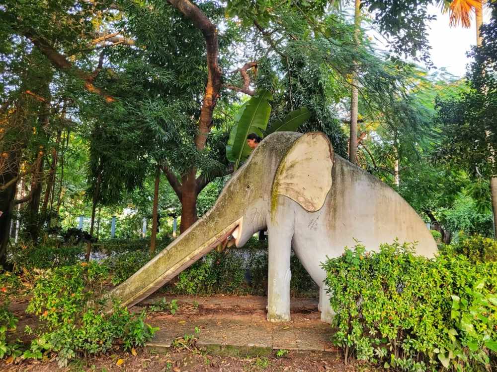 a woman riding a stone elephant ride in a park in rabindranath tagore sarovar in calcutta