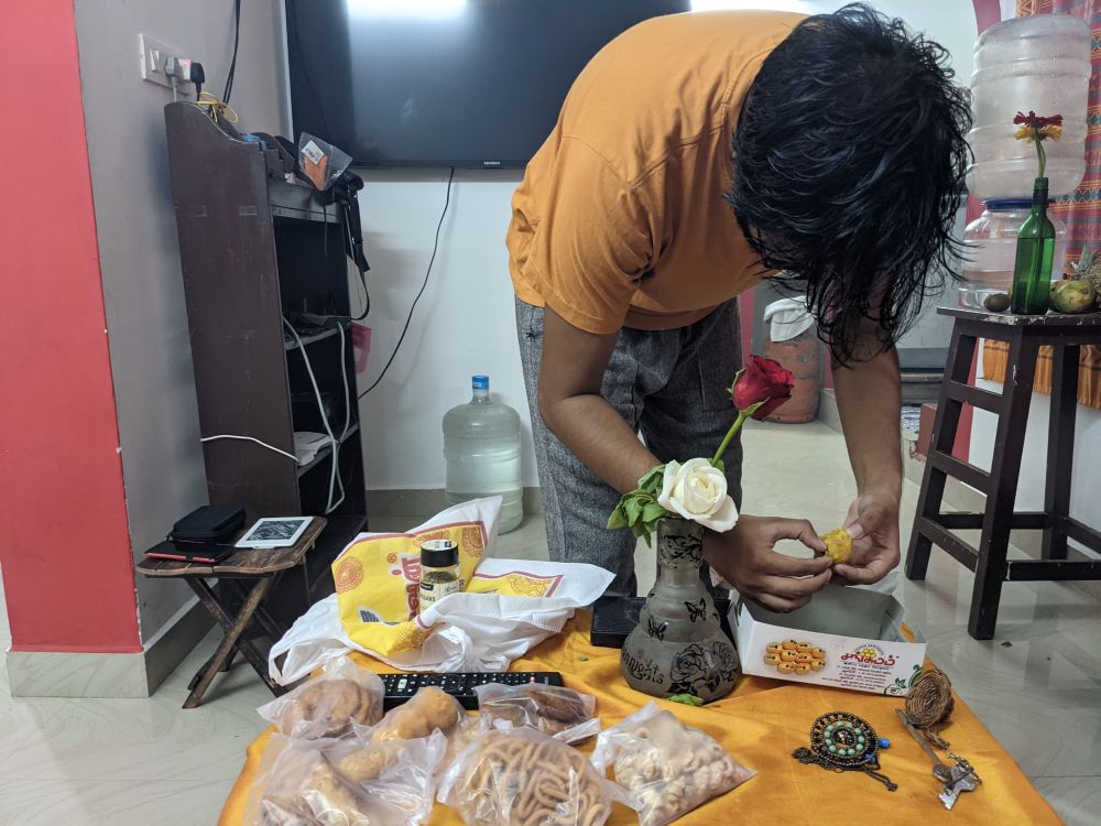 enjoying sweets given to us by a tamil family

a man eating laddoo and various sweets on the table