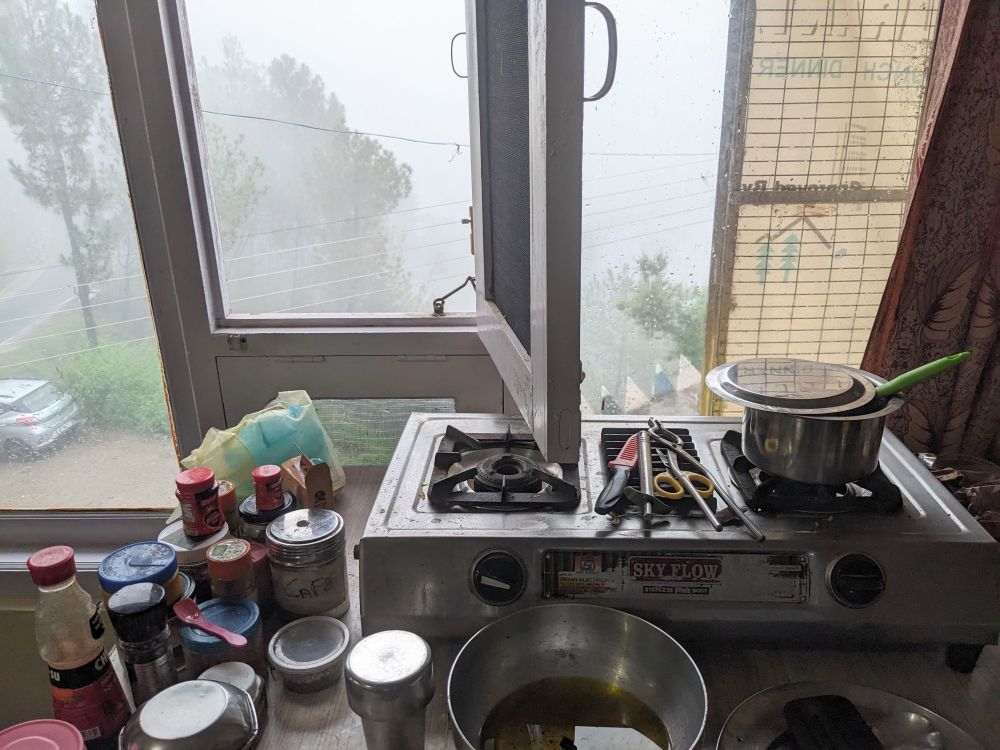 makeshift kitchen on table with window behind with a view