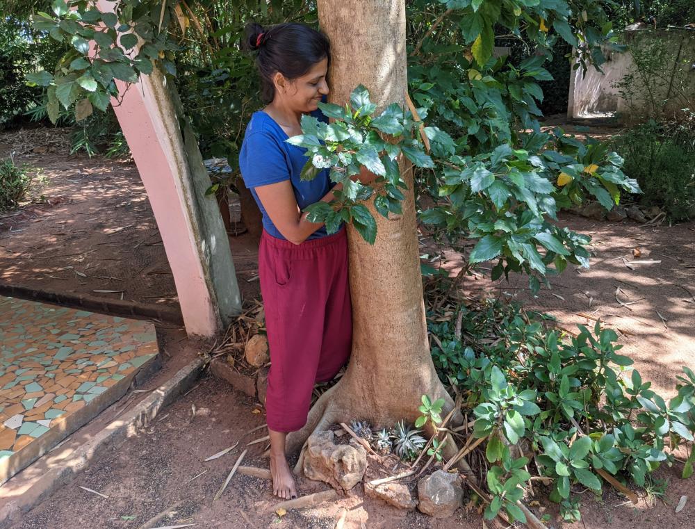 thankful for all i have gotten on the road. the author hugging a tree in a forest