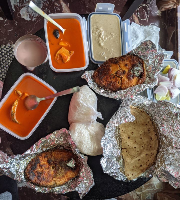 that fish curry and fish fry and roti 1 and rice on a table