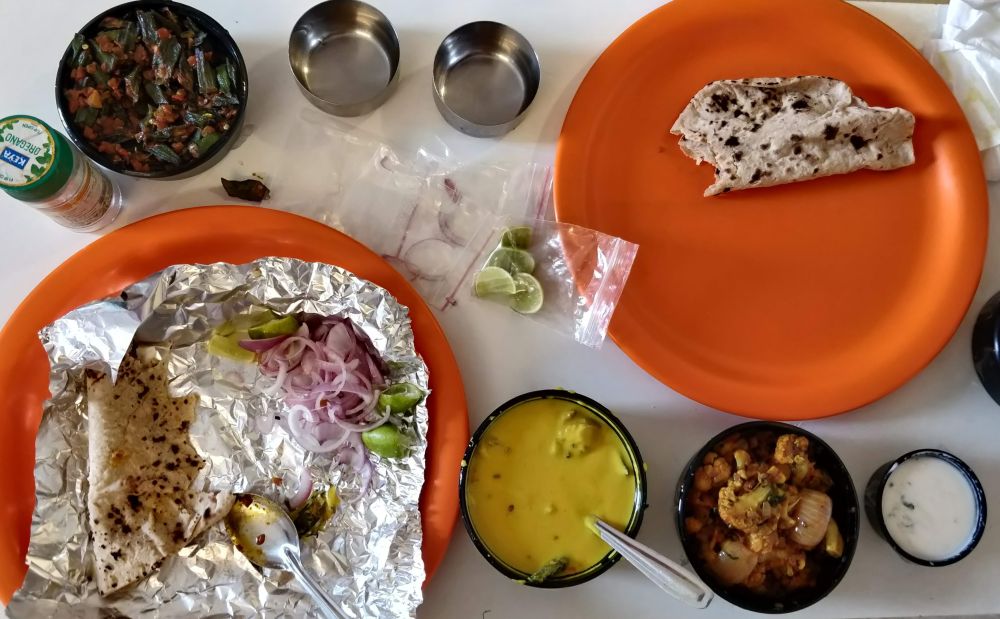 meal on a table in picture bhindi roti gobhi salad kadhi indian food