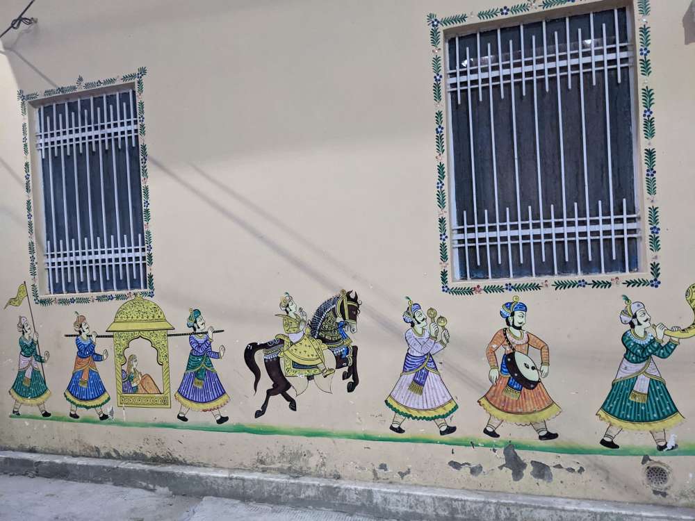 at one point you really dont know what to say dancers paintings at a wedding painted on a wall carriers bride in palki groom on horse