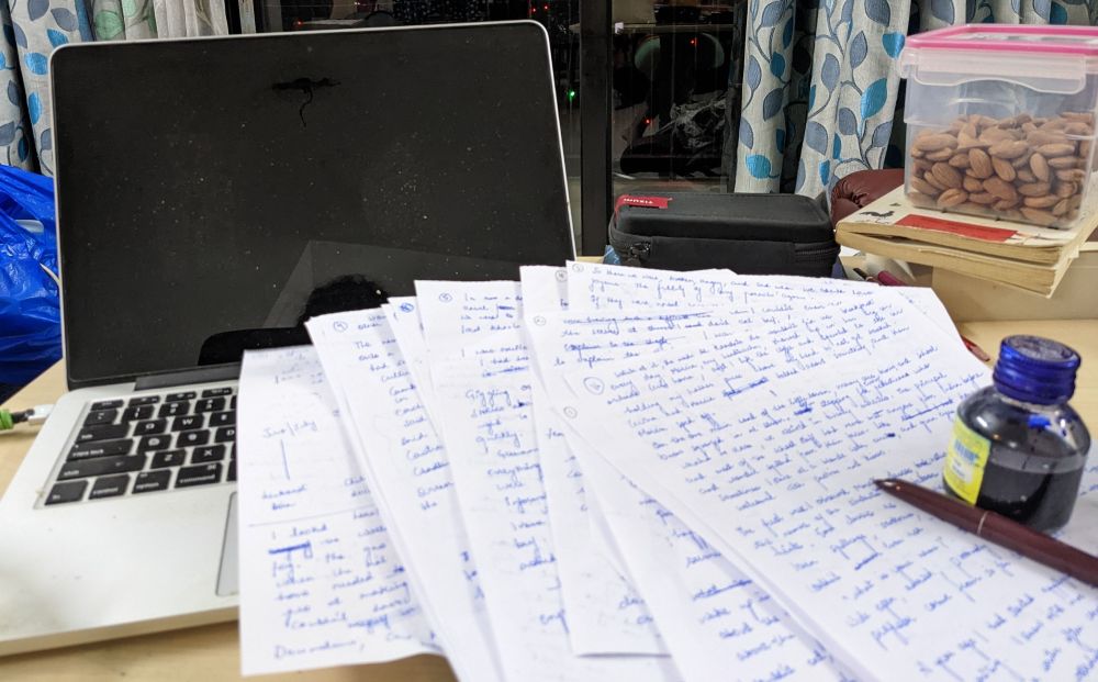 How to Edit a Memoir: 39 Tips I Used to Edit My 5-Star Travel Memoir 1 writing with hand papers with lot of ink writing ink pot computer