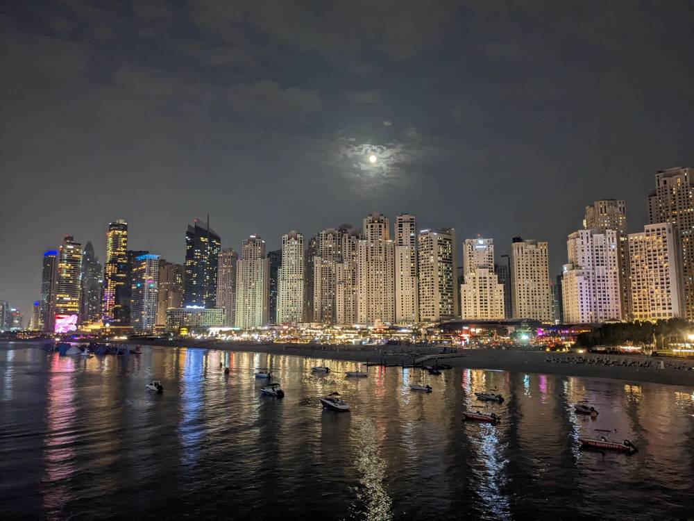 Dubai creek at night lights water shimmering buildings