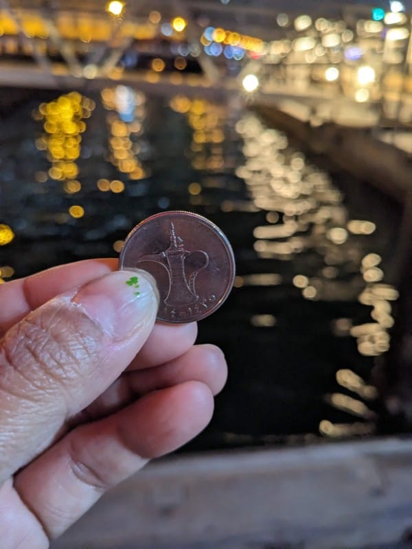 UAE one dirham coin to board the boat old dubai UAE
