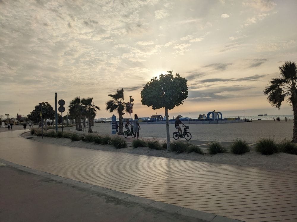 people relaxing at kite beach while i am worried about my flight (1) left india stuck in dubai beach photo trees people cycling sunset