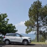beautiful brezza car parked in himachal mountains india feature image for buy a used car versus new car in bangalore karnataka (1)