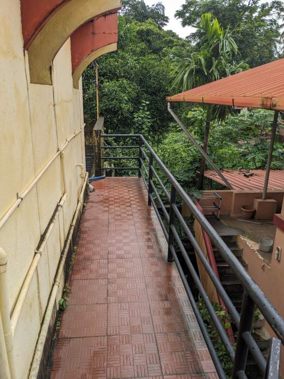 the porch leading to the terrace of the house green trees in background accommodation in mangalore (1)
